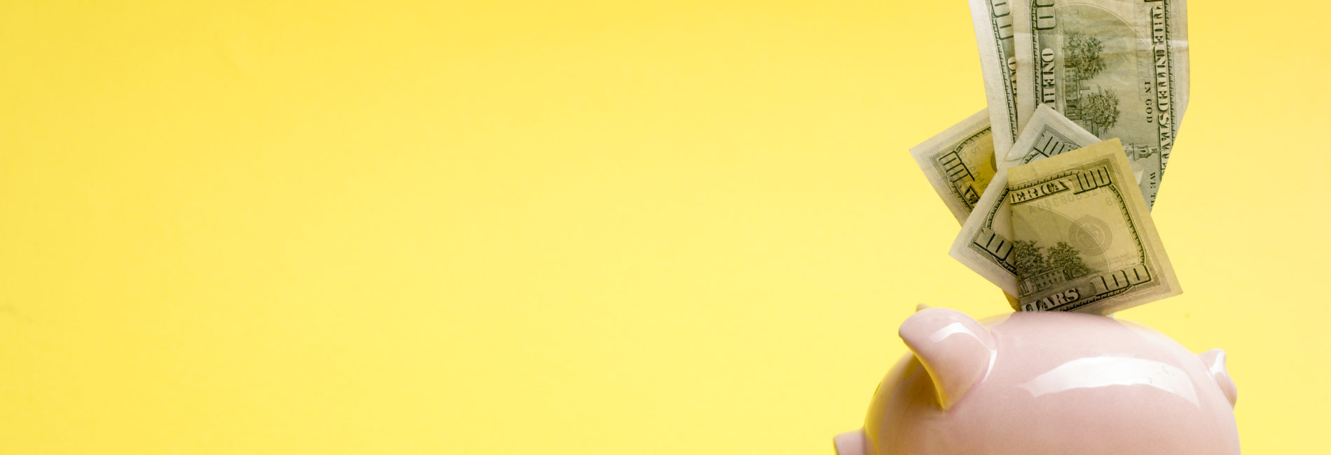 Piggy bank isolated on yellow background