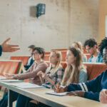 Professor giving a lecture to several students in a classroom
