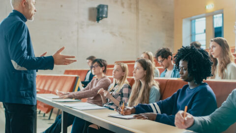 Professor giving a lecture to several students in a classroom