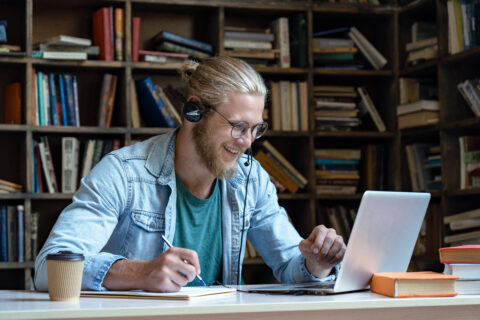 A student is sitting at his laptop, doing work on continuous learning.