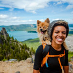 A woman hiking with her dog while on vacation