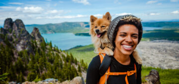 A woman hiking with her dog while on vacation