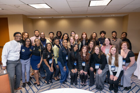 A group of students, volunteers, and certificate facilitators posing for a group photo at Elevate 2025.